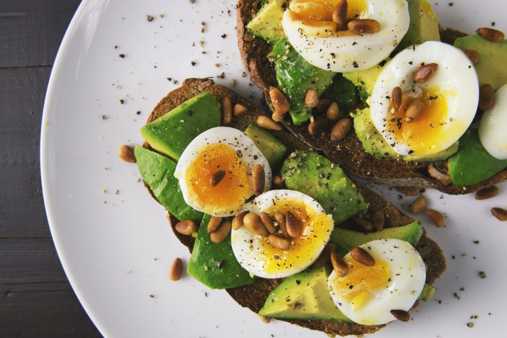 Eggs, nuts, diced avocado on a plate