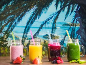 Four tropical smoothies in mason jar mugs