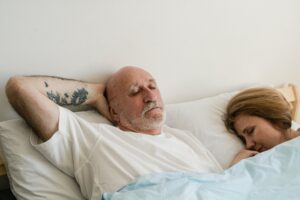 Man and woman sleeping in bed